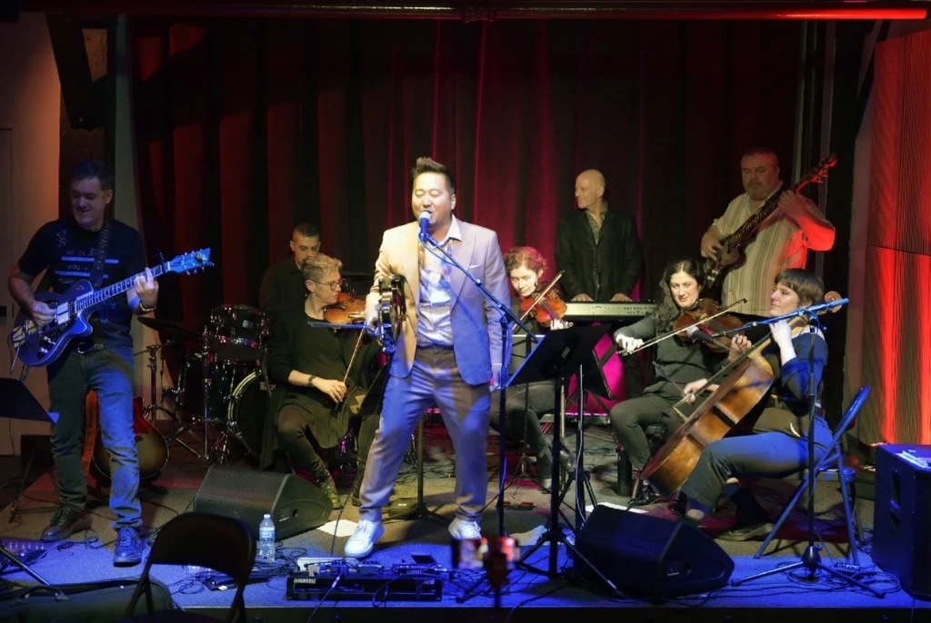 Kishi Bashi performing with band and strings